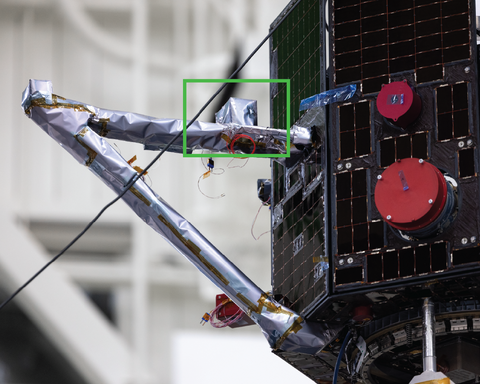 Picture of the MAGIC instrument under blankets and mounted on the bracket boom 