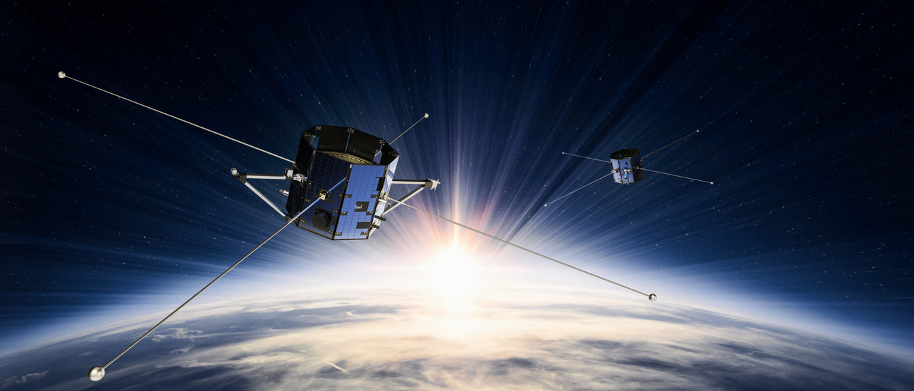 A rendered image of the two TRACERS satellites in orbit above Earth, highlighted by the sun beginning to shine from behind Earth