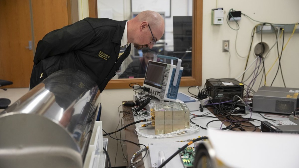 Dr. David Miles inspects an instrument while engineers run capability tests at Van Allen Hall in Iowa City on Monday, Oct. 16, 2023.