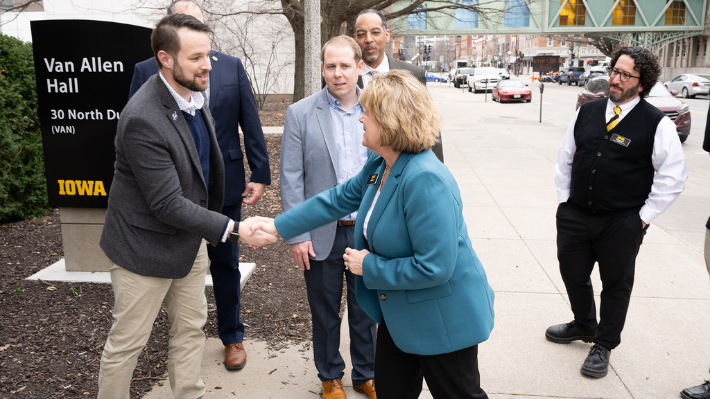 A photo of University of Iowa president Barbara Wilson shaking hands with Joseph Westlake, the heliophysics division director at NASA. Also included in the photo are Bradley Williams and David Carter of NASA and Joshua Weiner, the associate dean for research and infrastructure in the College of Liberal Arts and Sciences and professor in Biology at Iowa.