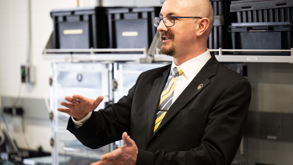 A photo of Dr. David Miles talking to people on a tour