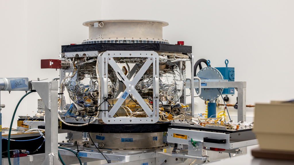 A completed TRACERS satellite, without the walls, sits on a support structure in a clean room