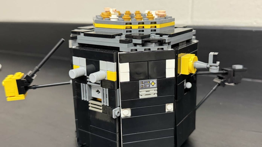 A photo of one TRACERS satellite lego model on a black counter top.