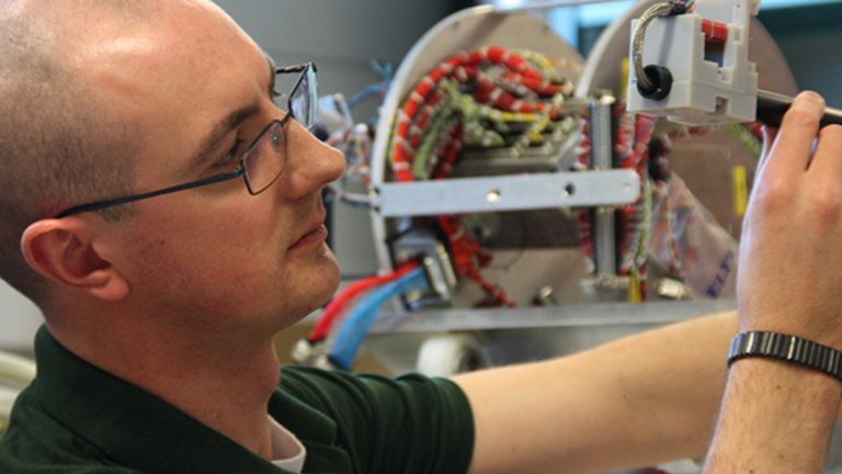 An image of Professor David Miles, the newly named principal investigator for the TRACERS mission, inspecting an instrument.